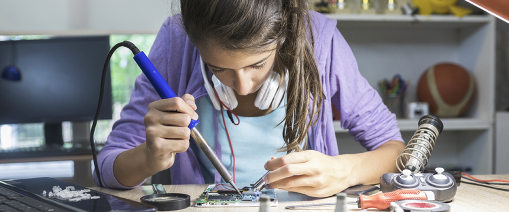 girl is soldering with a soldering depot