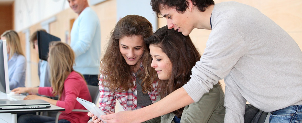 Teenager working together with a tablet computer