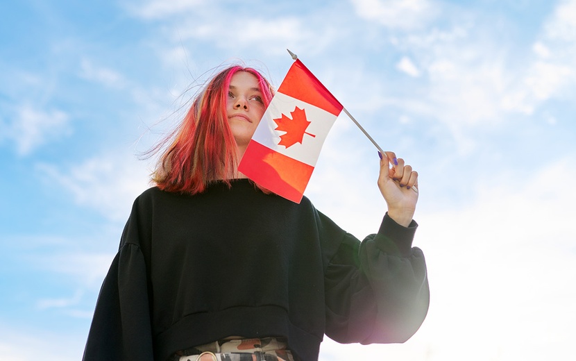 Mädchen hält Kanadaflagge in der Hand.